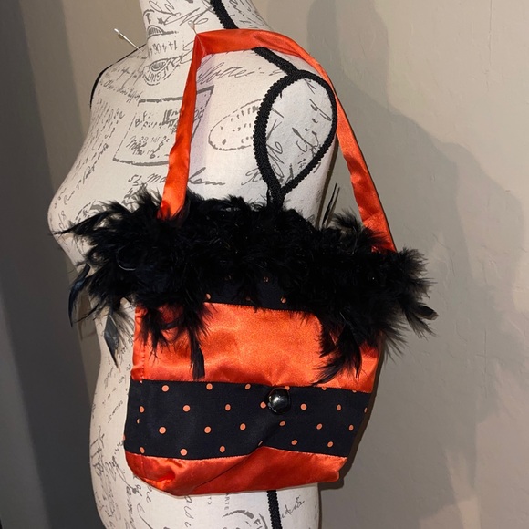 Halloween Handbag with black feathers and a bell on the front. - Picture 1 of 11